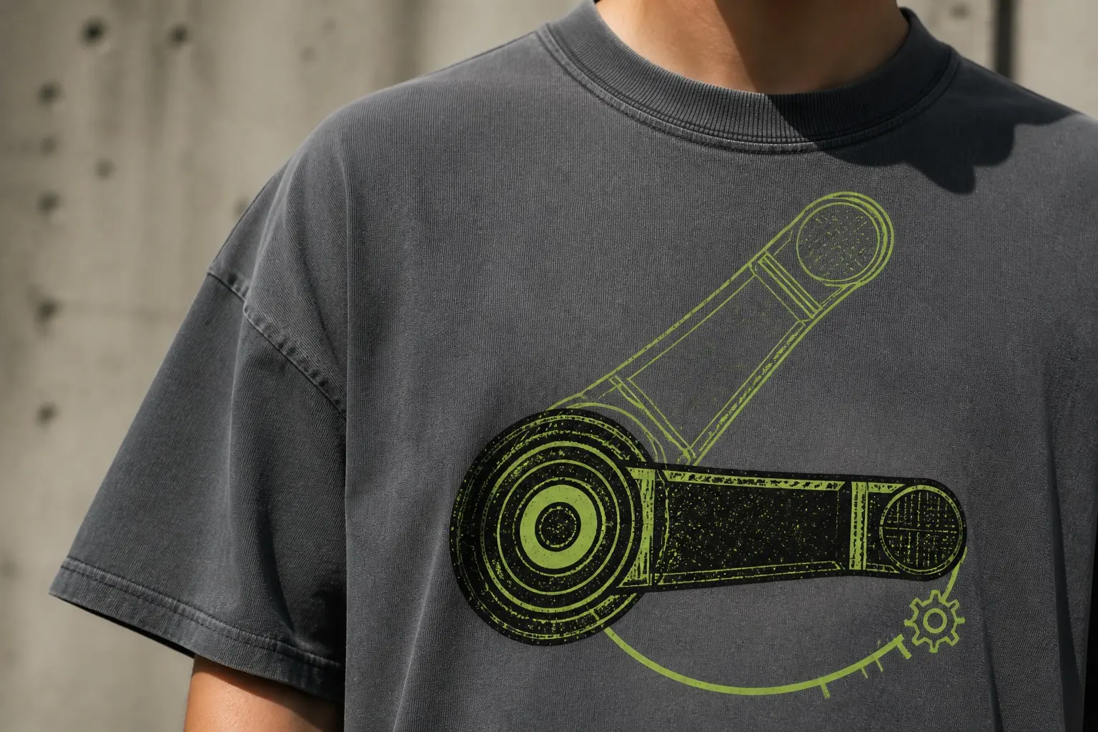 A steel-grey tee printed with one film advance lever drawn very large and straight on, in two positions at once — closed drawn solid, fully swung drawn in outline — with a curved arc marking the sweep between them and a small ratchet detail where it stops, no camera and no text.